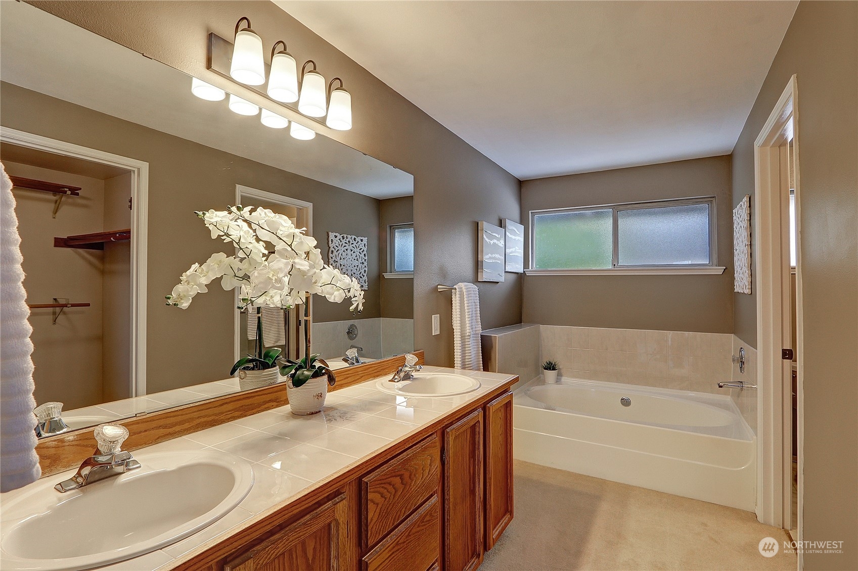 2332 238th Place Southeast Bothell, WA 98021 - Photo 25 of 32 a bathroom with a bathtub a sink and a mirror