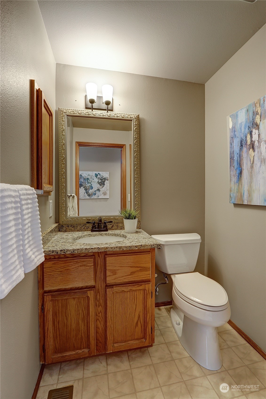 2332 238th Place Southeast Bothell, WA 98021 - Photo 8 of 32 a bathroom with a granite countertop toilet sink and mirror
