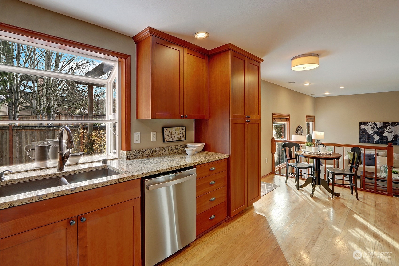 2332 238th Place Southeast Bothell, WA 98021 - Photo 10 of 32 a kitchen with stainless steel appliances granite countertop dining table chairs and wooden floors