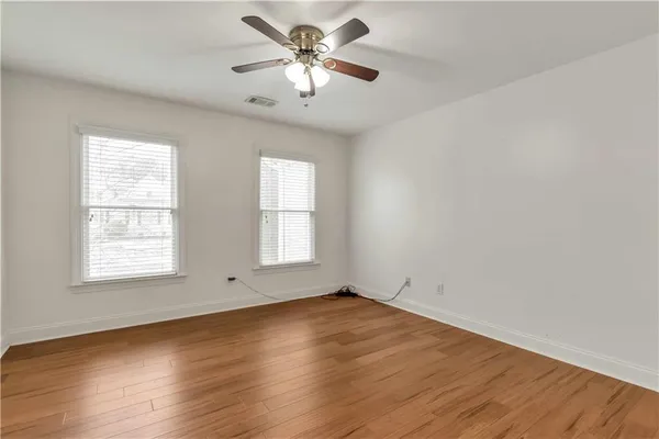 wooden floor in an empty room with a window