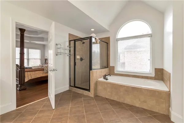 a spacious bathroom with a tub and a shower