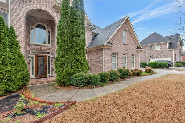 a front view of a house with garden
