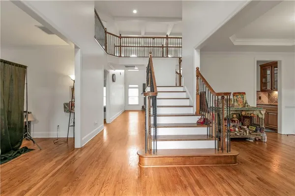 a view of entryway and hall with wooden floor