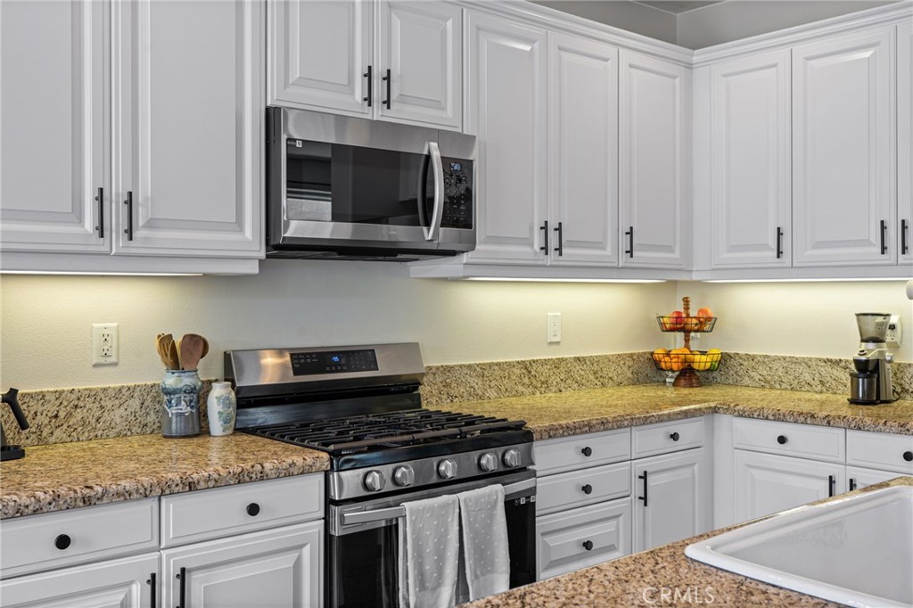 28356 Santa Rosa Lane Saugus, CA 91350 - Photo 7 of 50 a kitchen with granite countertop white cabinets and stainless steel appliances