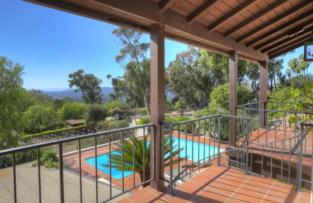 a view of a balcony with wooden floor