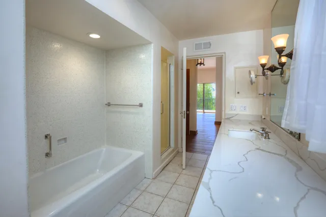 a bathroom with a bathtub and shower