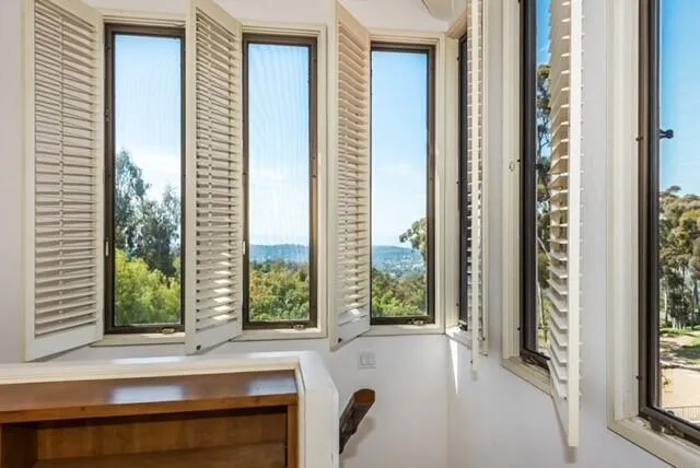 a bathroom with a bathtub and windows