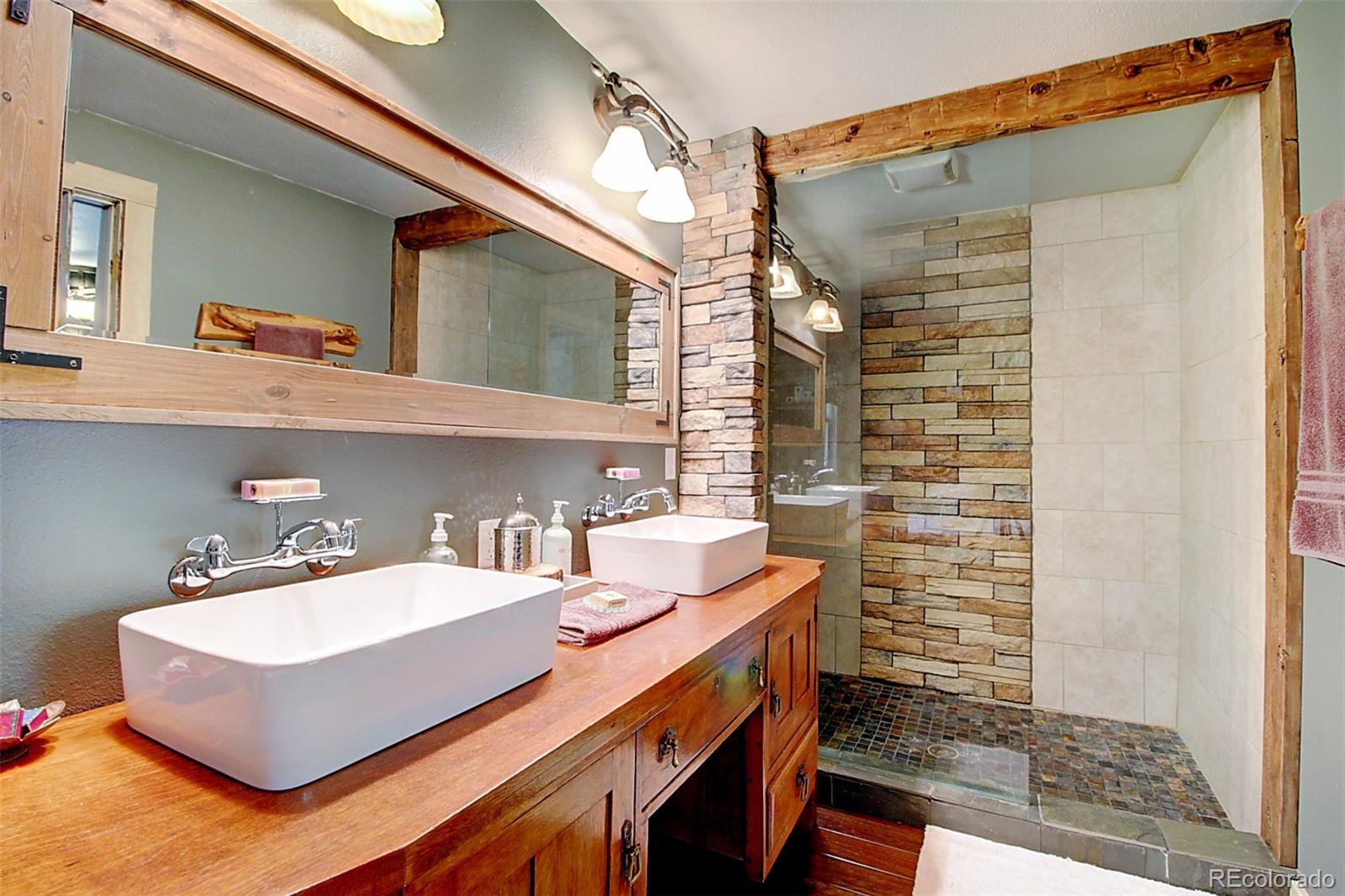 135 Nova Drive Pine, CO 80470 - Photo 11 of 38 a bathroom with a sink and a mirror