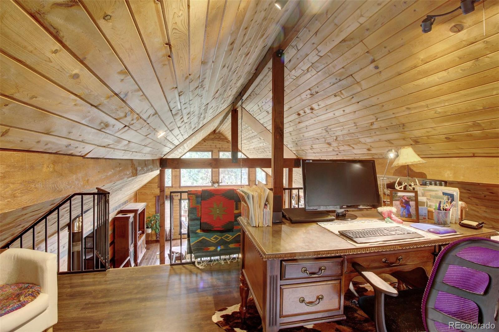 135 Nova Drive Pine, CO 80470 - Photo 16 of 38 a dining room with furniture and wooden floor