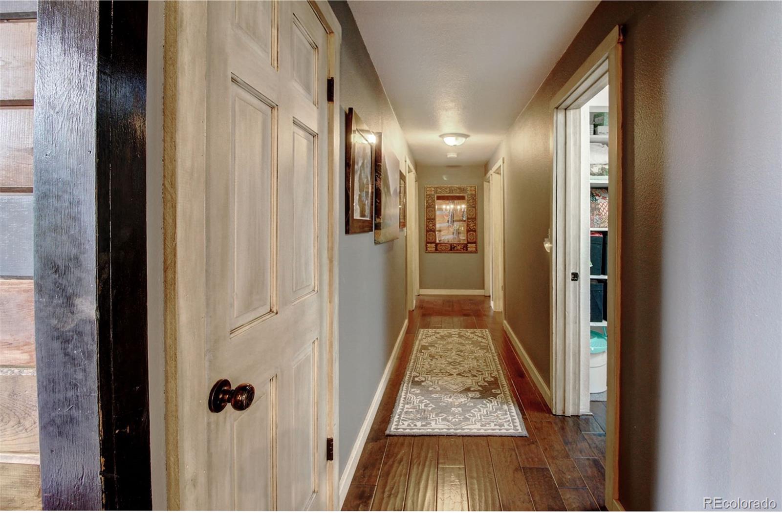 135 Nova Drive Pine, CO 80470 - Photo 20 of 38 a view of hallway with wooden floor