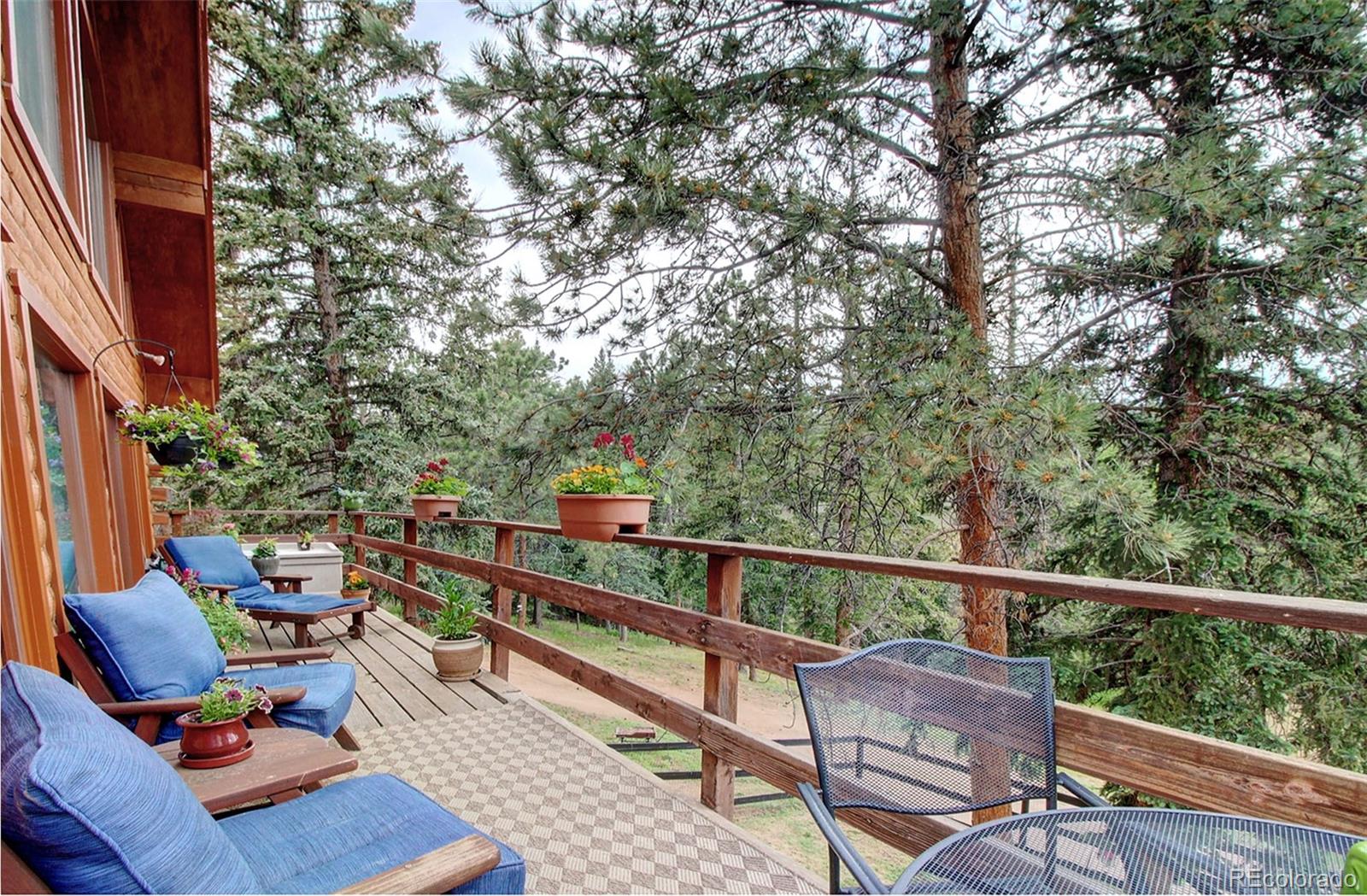 135 Nova Drive Pine, CO 80470 - Photo 24 of 38 a view of balcony with furniture and wooden fence