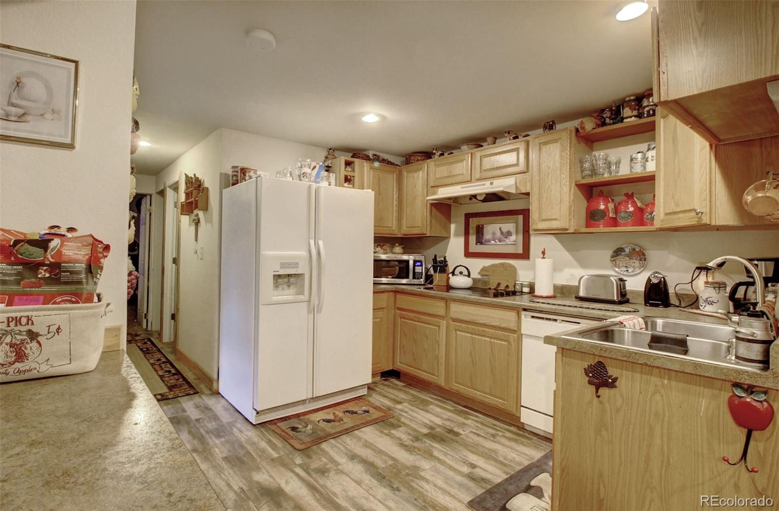135 Nova Drive Pine, CO 80470 - Photo 29 of 38 a kitchen with stainless steel appliances granite countertop a refrigerator and a sink