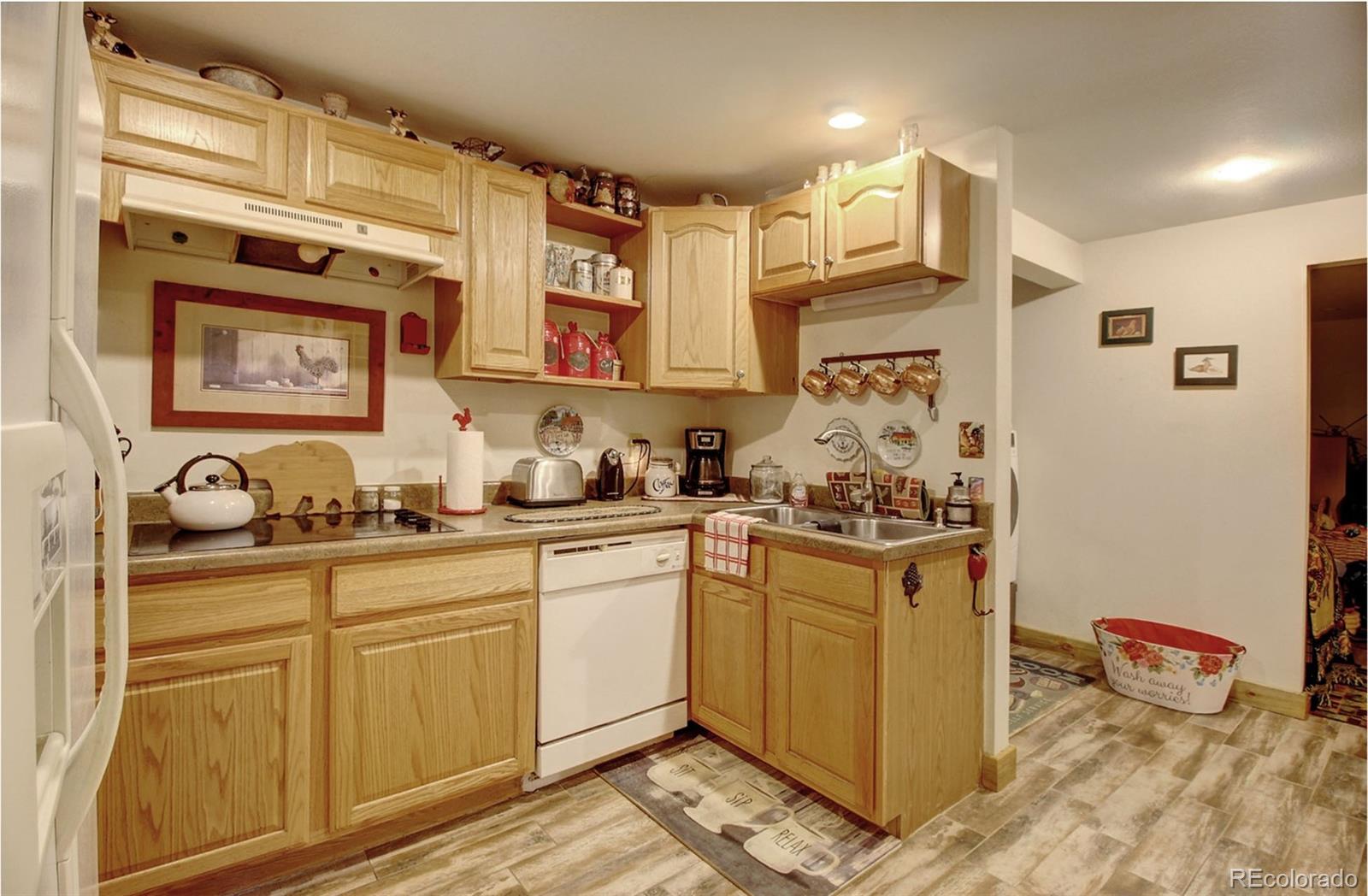 135 Nova Drive Pine, CO 80470 - Photo 30 of 38 a kitchen with stainless steel appliances granite countertop a sink and cabinets