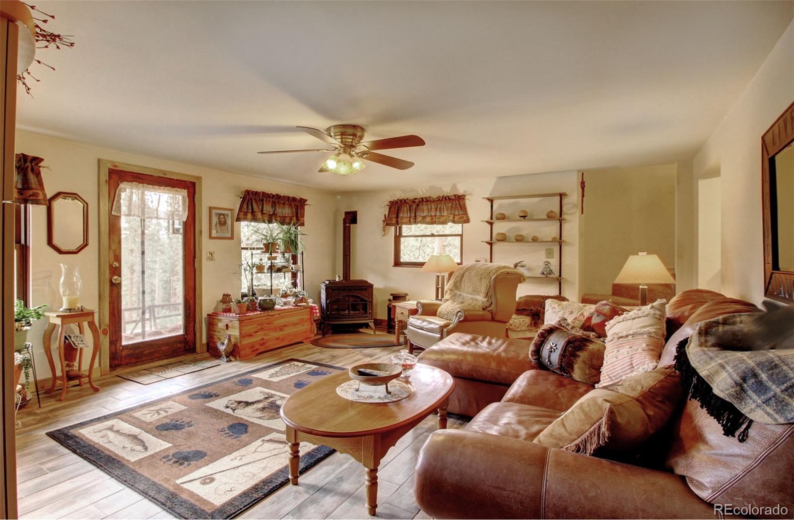 135 Nova Drive Pine, CO 80470 - Photo 32 of 38 a living room with furniture a rug and a window