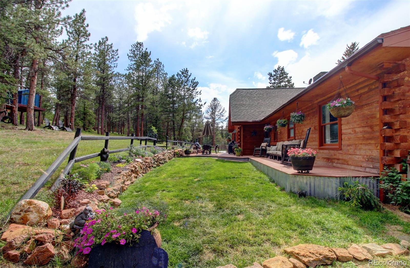 135 Nova Drive Pine, CO 80470 - Photo 36 of 38 a view of a house with backyard and sitting area