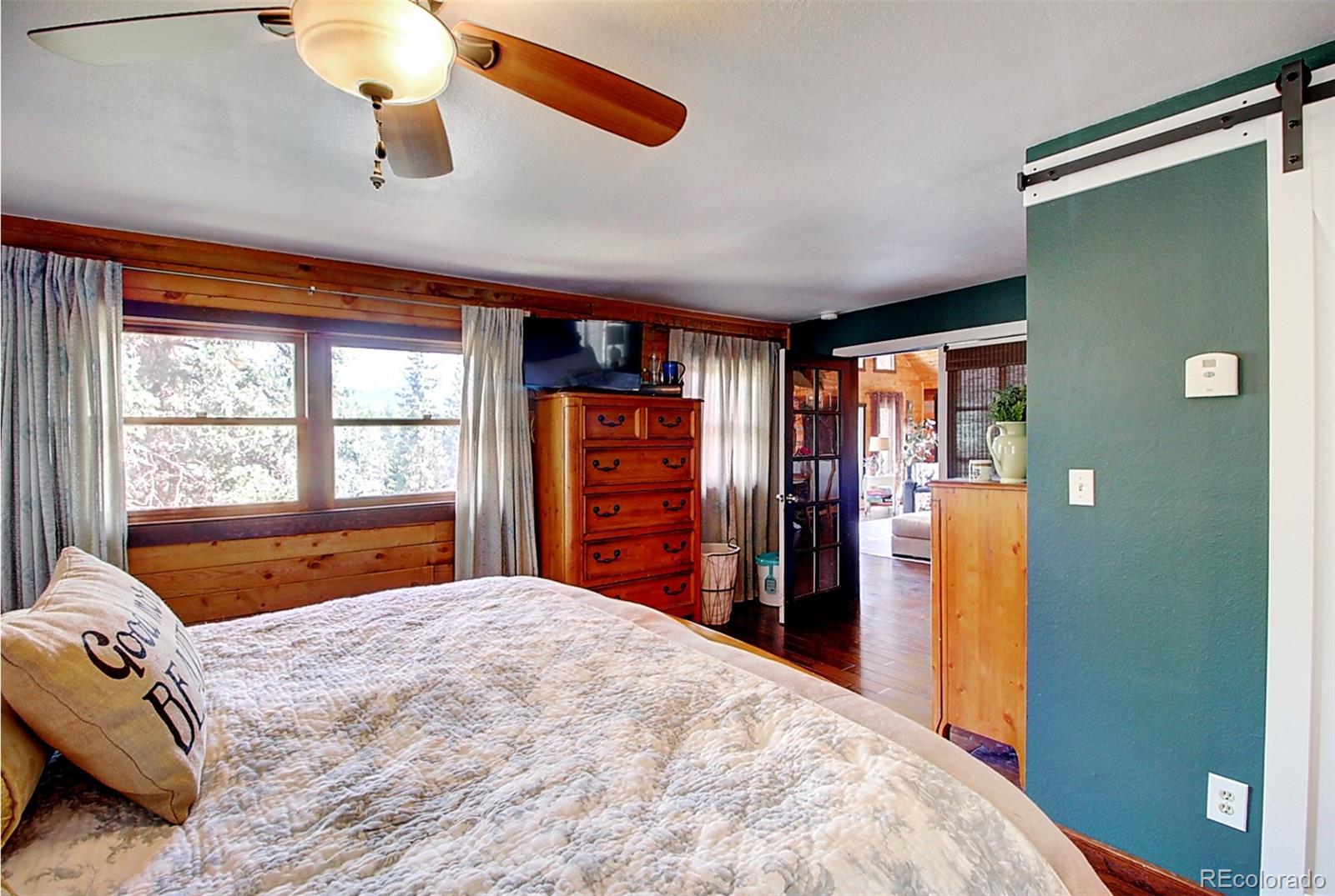 135 Nova Drive Pine, CO 80470 - Photo 9 of 38 a bedroom with a bed and a large window