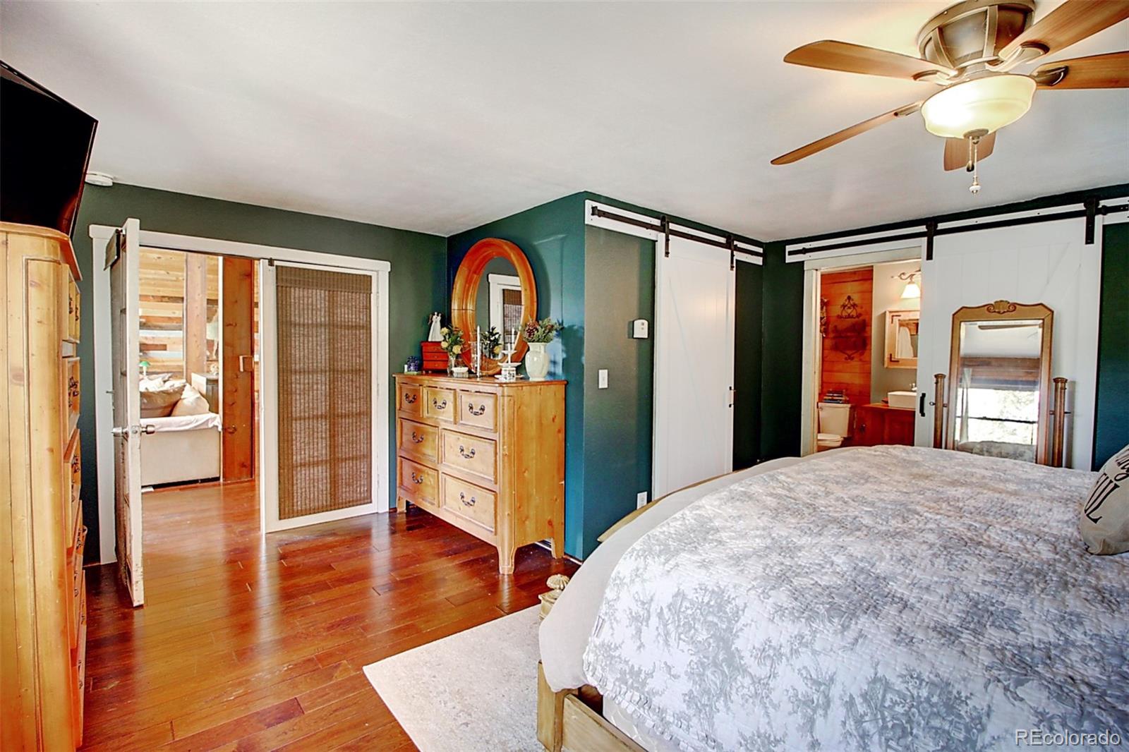 135 Nova Drive Pine, CO 80470 - Photo 10 of 38 a bedroom with a bed and a flat screen tv