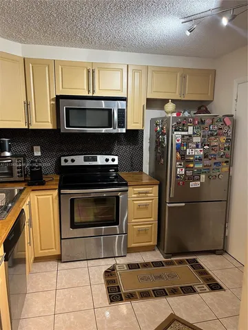 a kitchen with appliances and cabinets