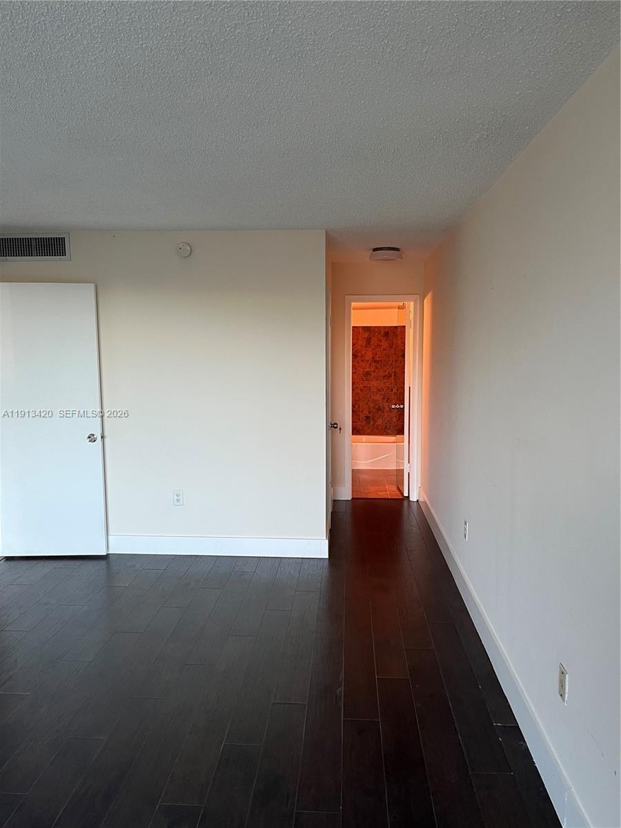 8233 Harding Avenue, Unit 305 Miami Beach, FL 33141 - Photo 25 of 39 a view of an empty room with wooden floor and a window