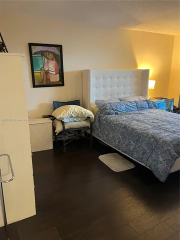 a bedroom with a bed and a large window with outer view