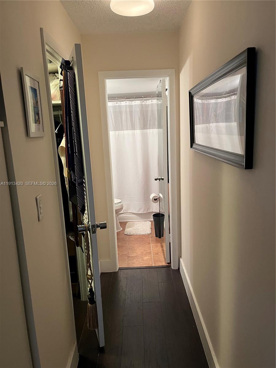 8233 Harding Avenue, Unit 305 Miami Beach, FL 33141 - Photo 26 of 39 a view of a hallway with wooden floor and a livingroom