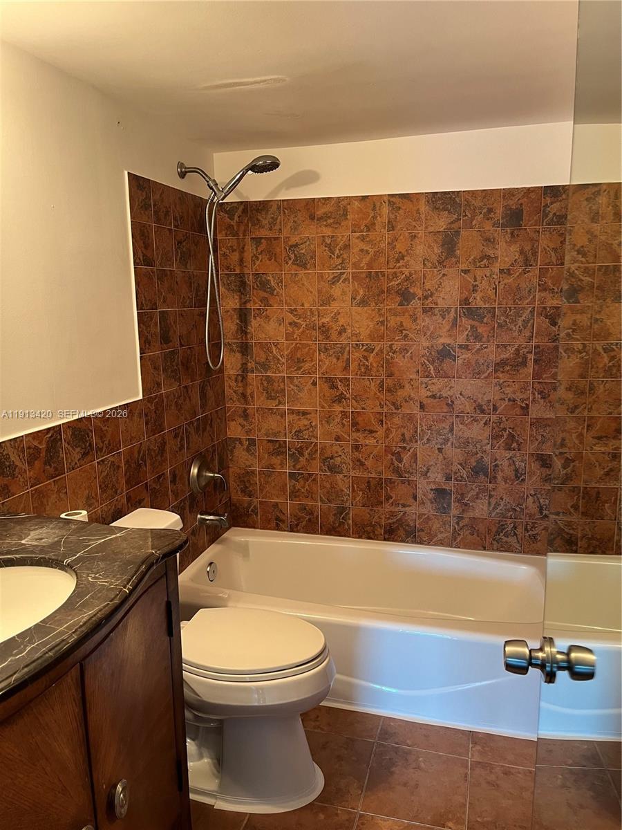 8233 Harding Avenue, Unit 305 Miami Beach, FL 33141 - Photo 29 of 39 a bathroom with a sink a toilet and shower