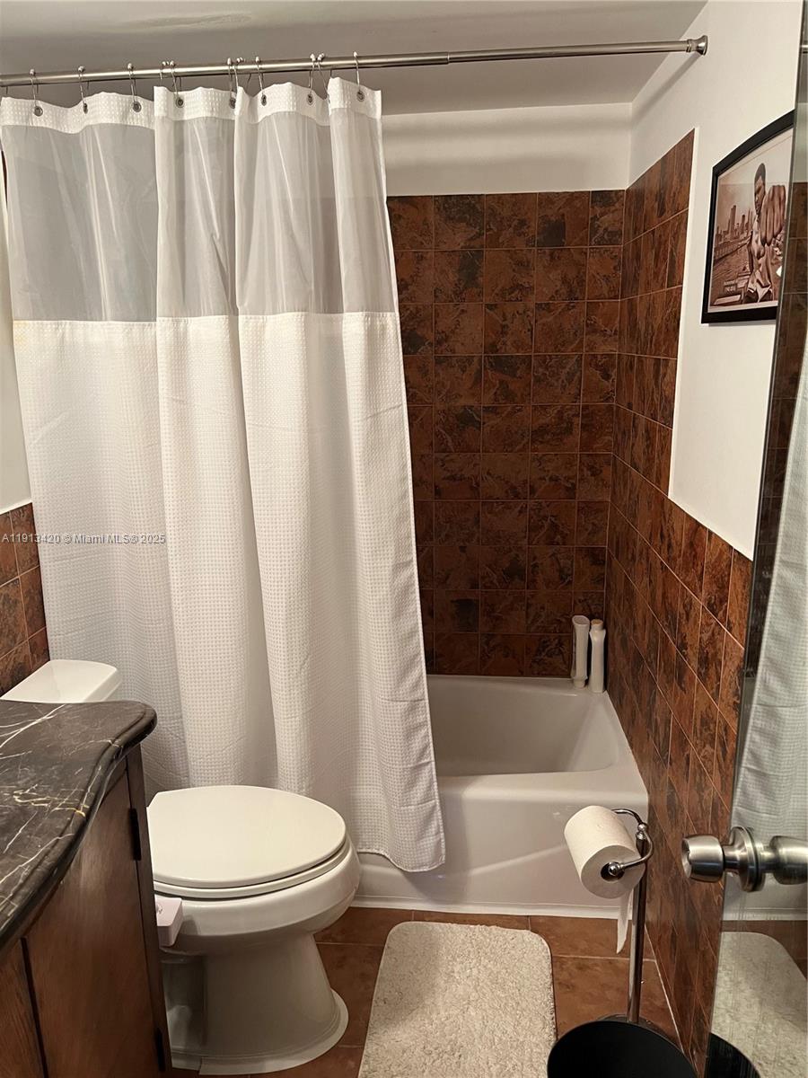 8233 Harding Avenue, Unit 305 Miami Beach, FL 33141 - Photo 30 of 46 a bathroom with a sink a toilet a tub and shower