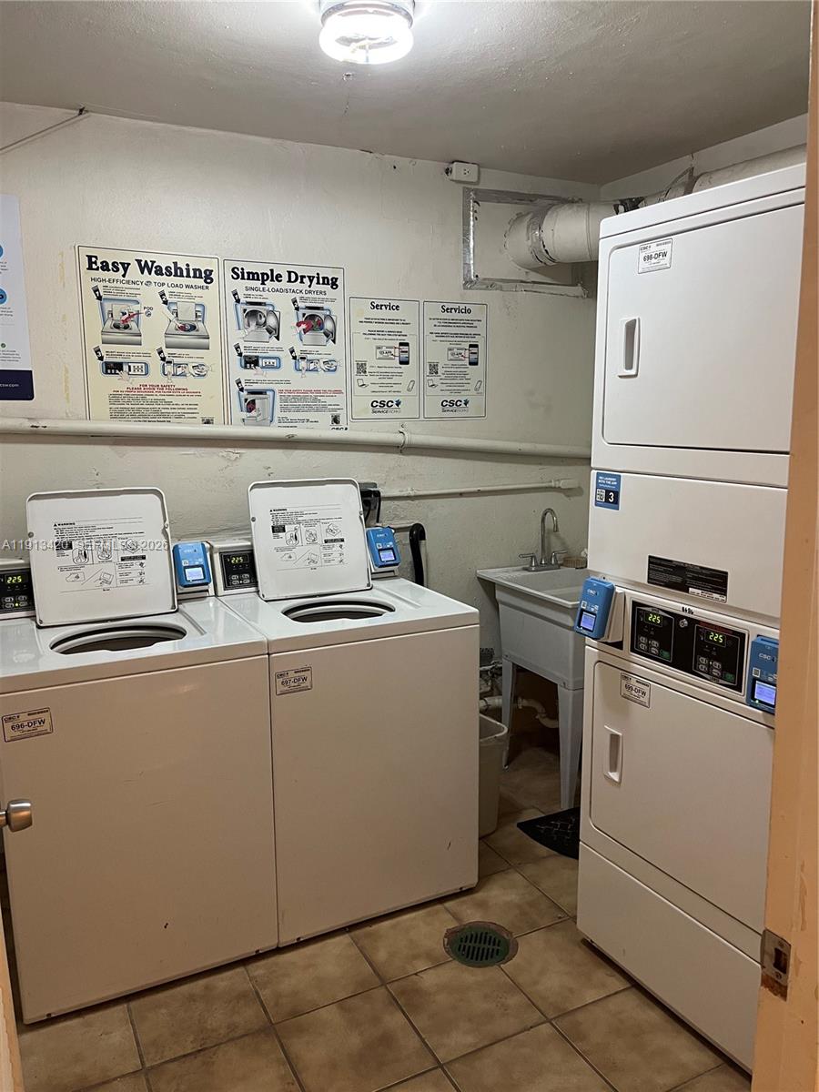 8233 Harding Avenue, Unit 305 Miami Beach, FL 33141 - Photo 34 of 39 a utility room with dryer and washer