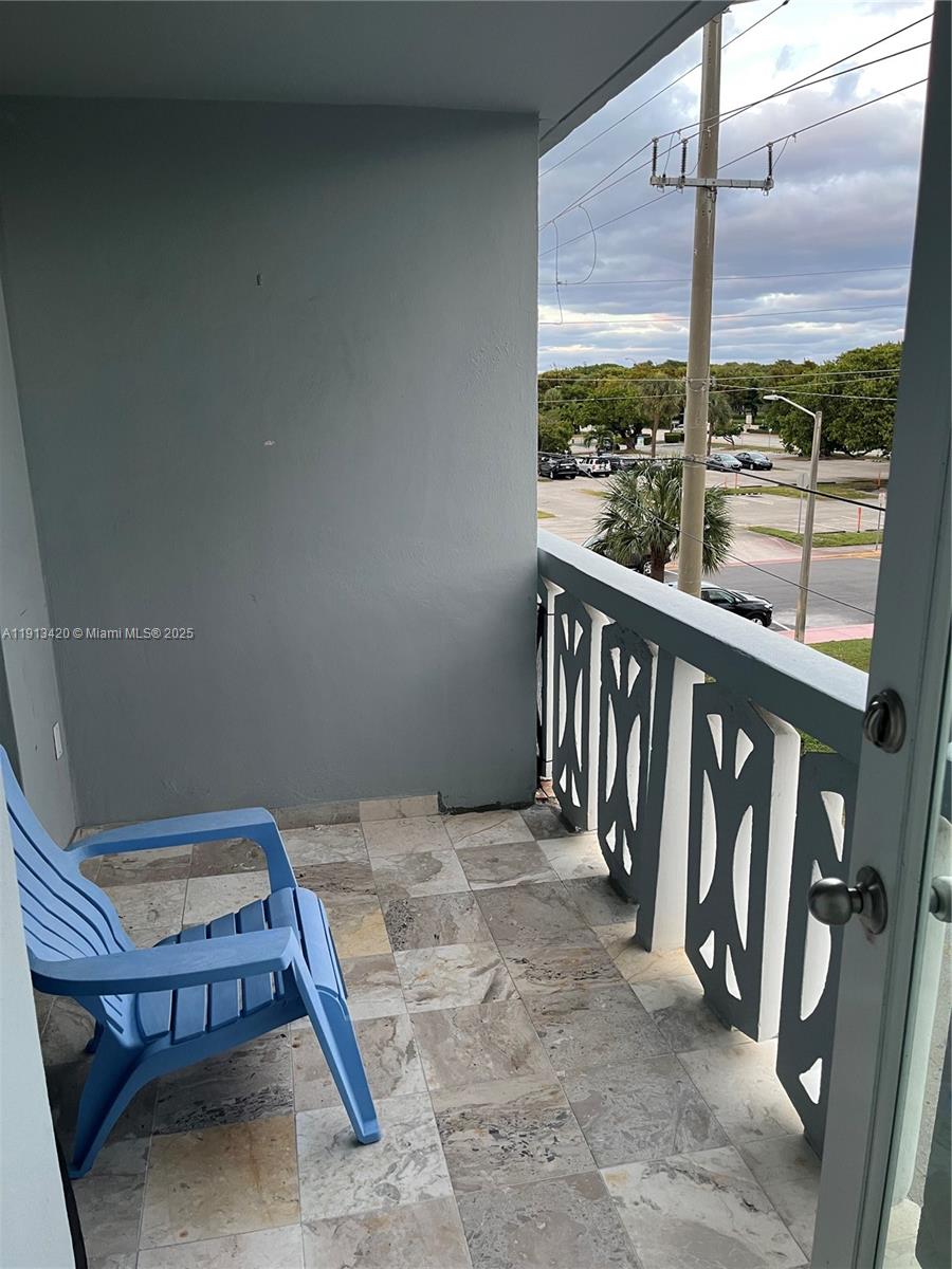 8233 Harding Avenue, Unit 305 Miami Beach, FL 33141 - Photo 38 of 46 a view of balcony with wooden floor and outdoor seating