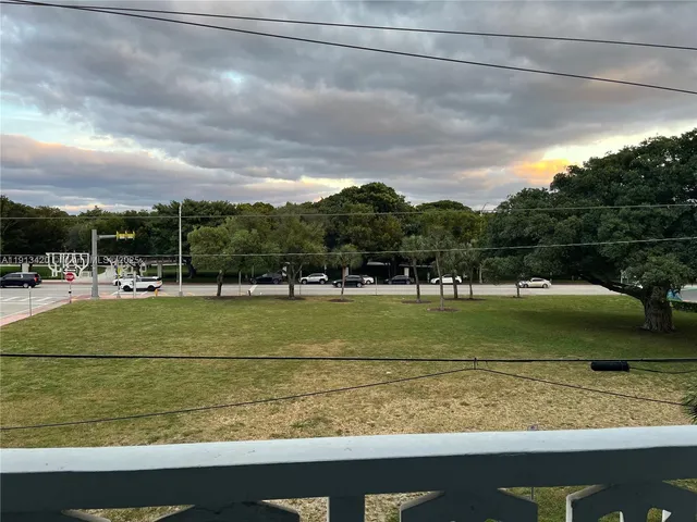 a dining room with a table chairs and a kitchen view
