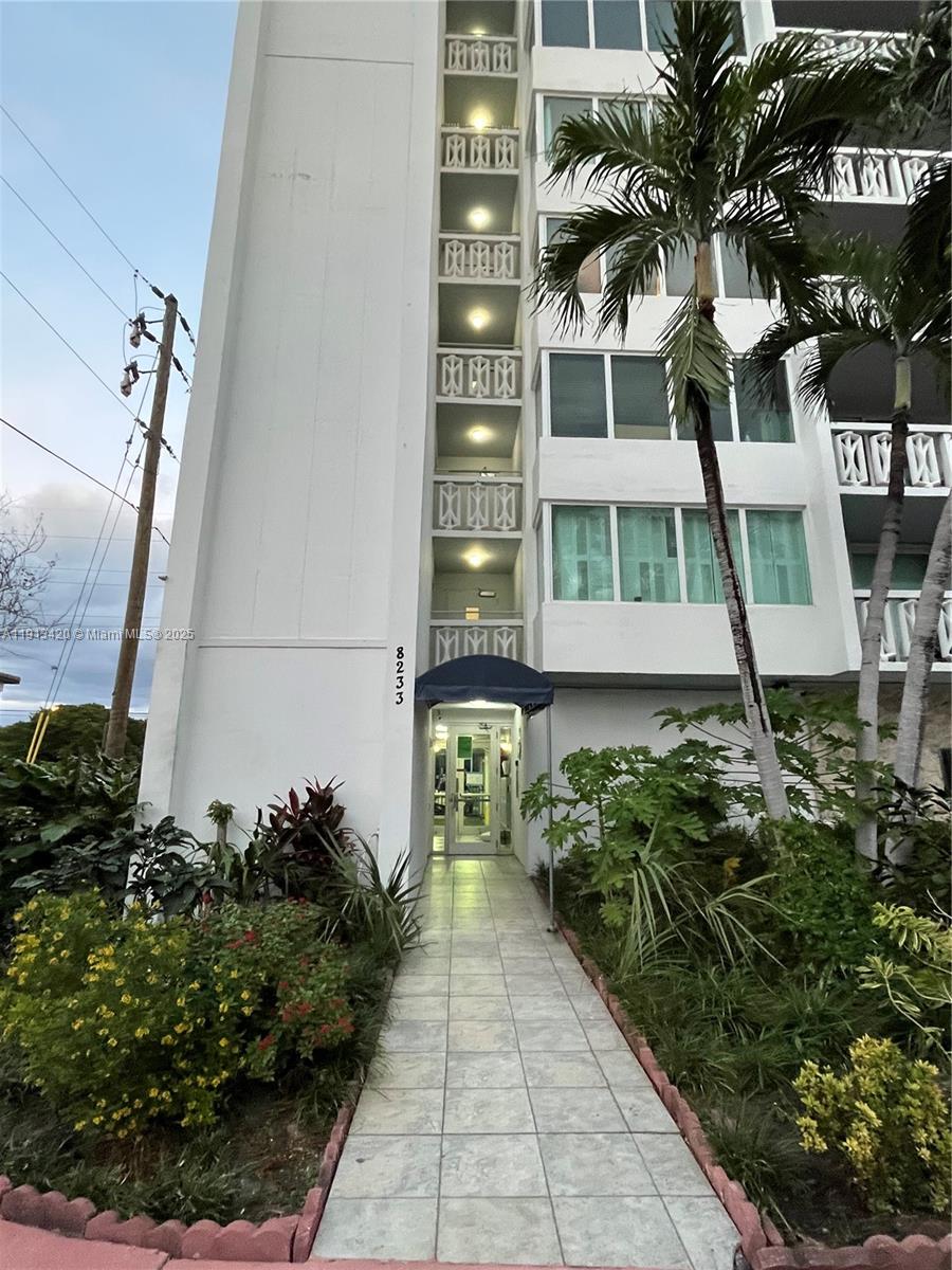 8233 Harding Avenue, Unit 305 Miami Beach, FL 33141 - Photo 4 of 46 a front view of a house with a garden