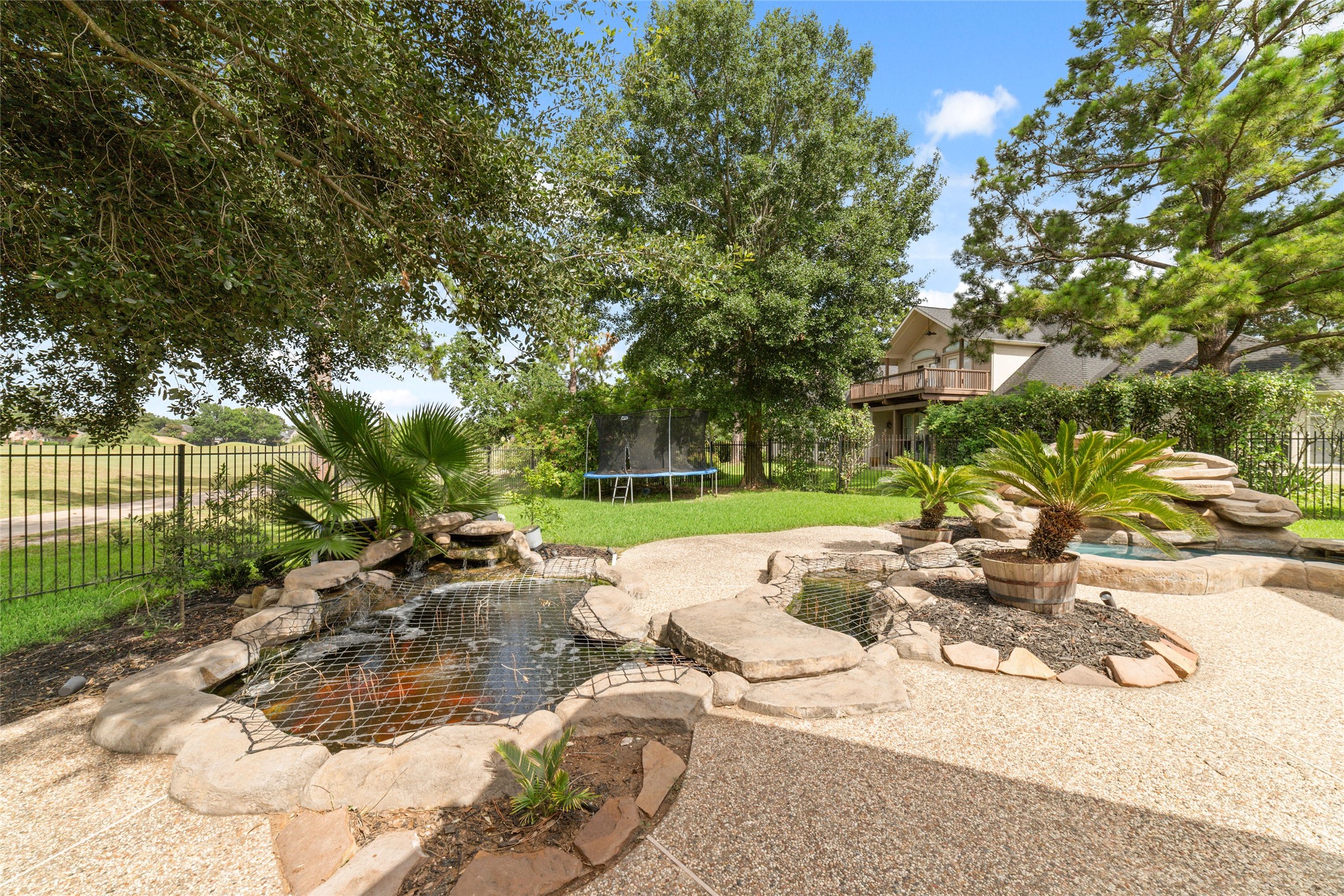 24203 Moon Ridge Court Katy, TX 77494 - Photo 38 of 43 This backyard features a tranquil, Koi pond stocked with authentic Japanese Koi fish giving a peaceful vibe to enjoy.