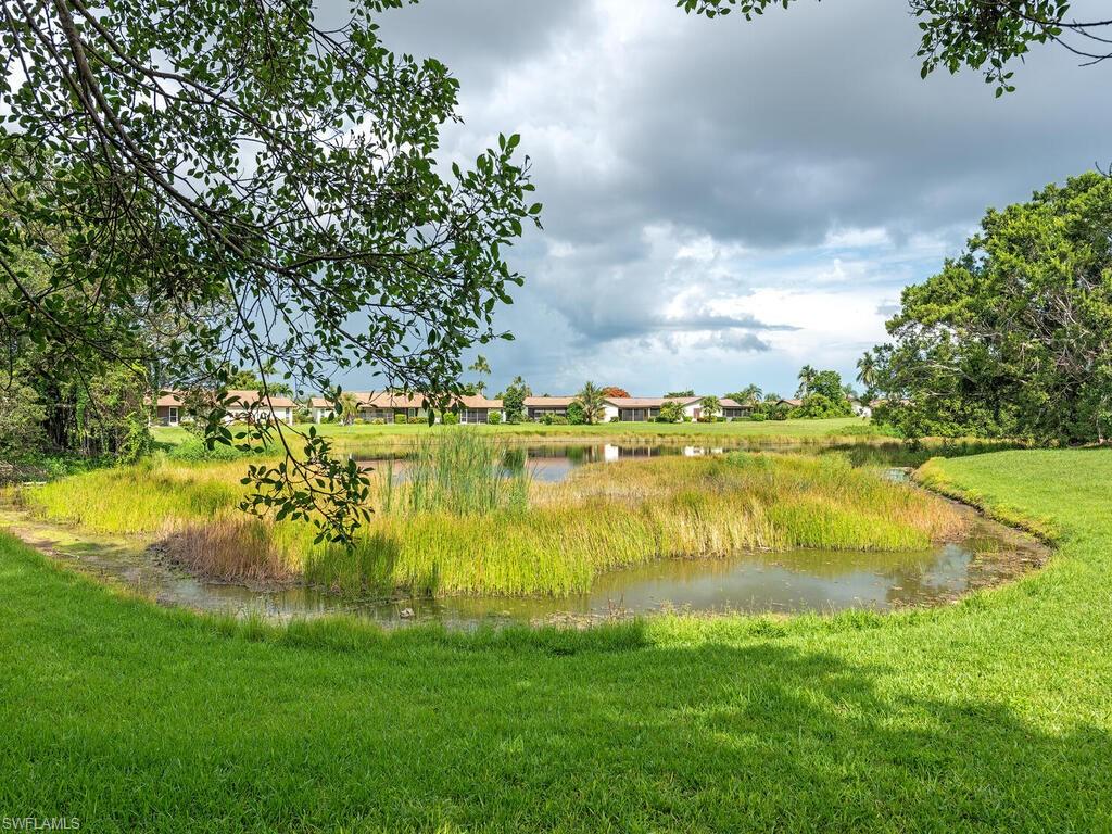 130 Round Key Circle, Unit G10 Naples, FL 34112 - Photo 12 of 12 a view of a lake with a big yard