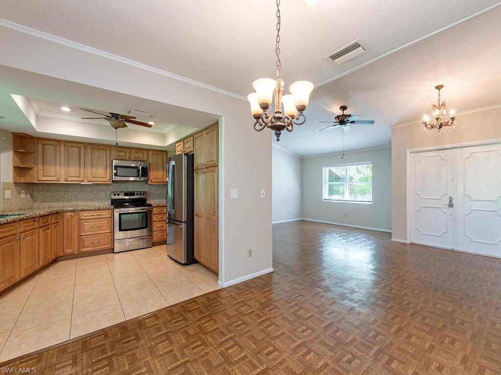 130 Round Key Circle, Unit G10 Naples, FL 34112 - Photo 3 of 12 a view of a kitchen with a sink stove and refrigerator