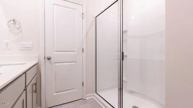 a bathroom with a shower and a sink