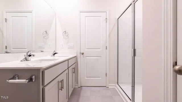 a bathroom with a double vanity sink and a mirror