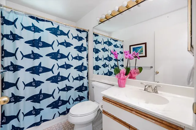 a bathroom with a sink toilet and shower