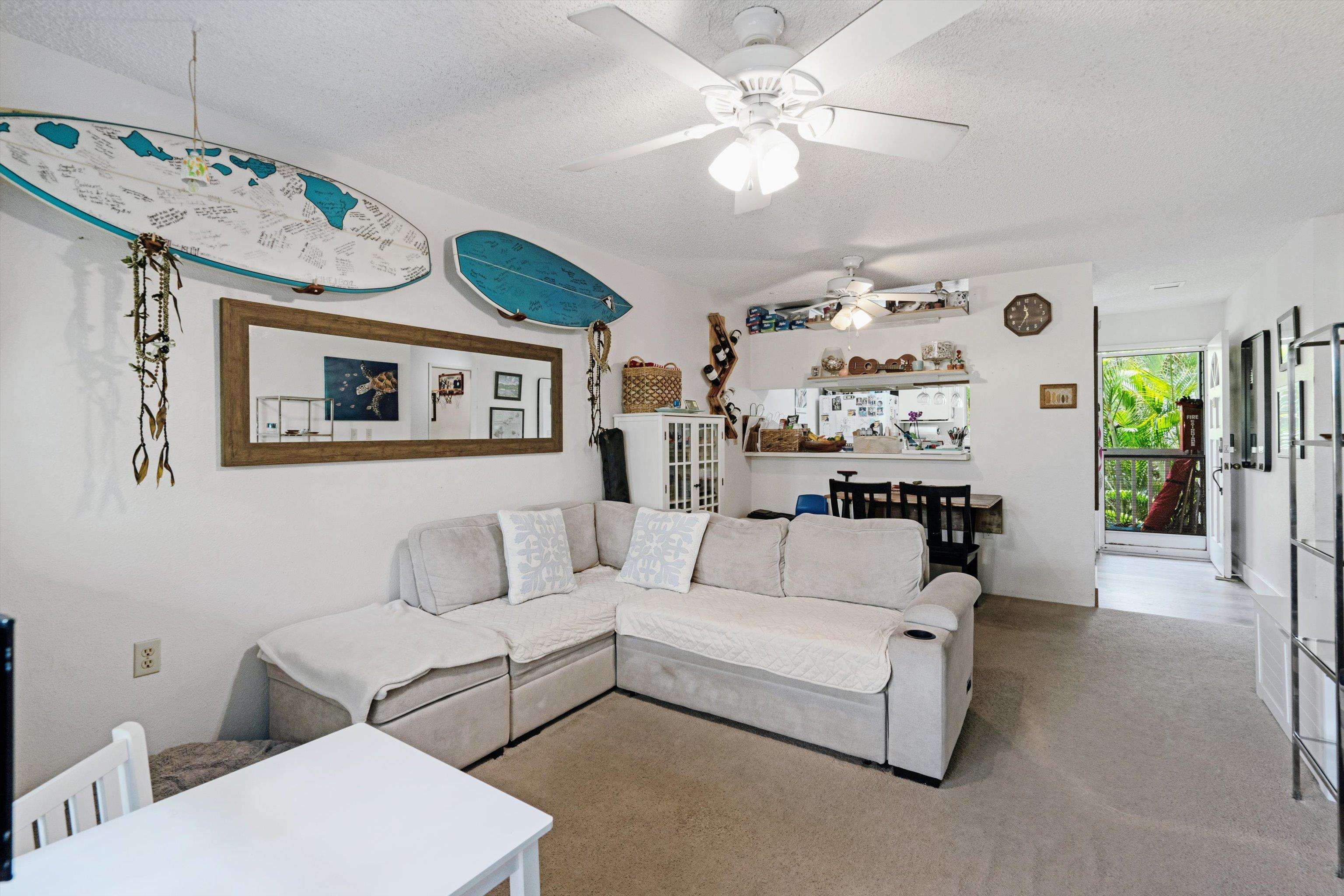 160 Keonekai Road, Unit 27201 Kihei, HI 96753 - Photo 2 of 29 a living room with furniture and a chandelier