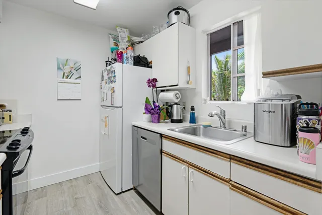a kitchen with refrigerator and window