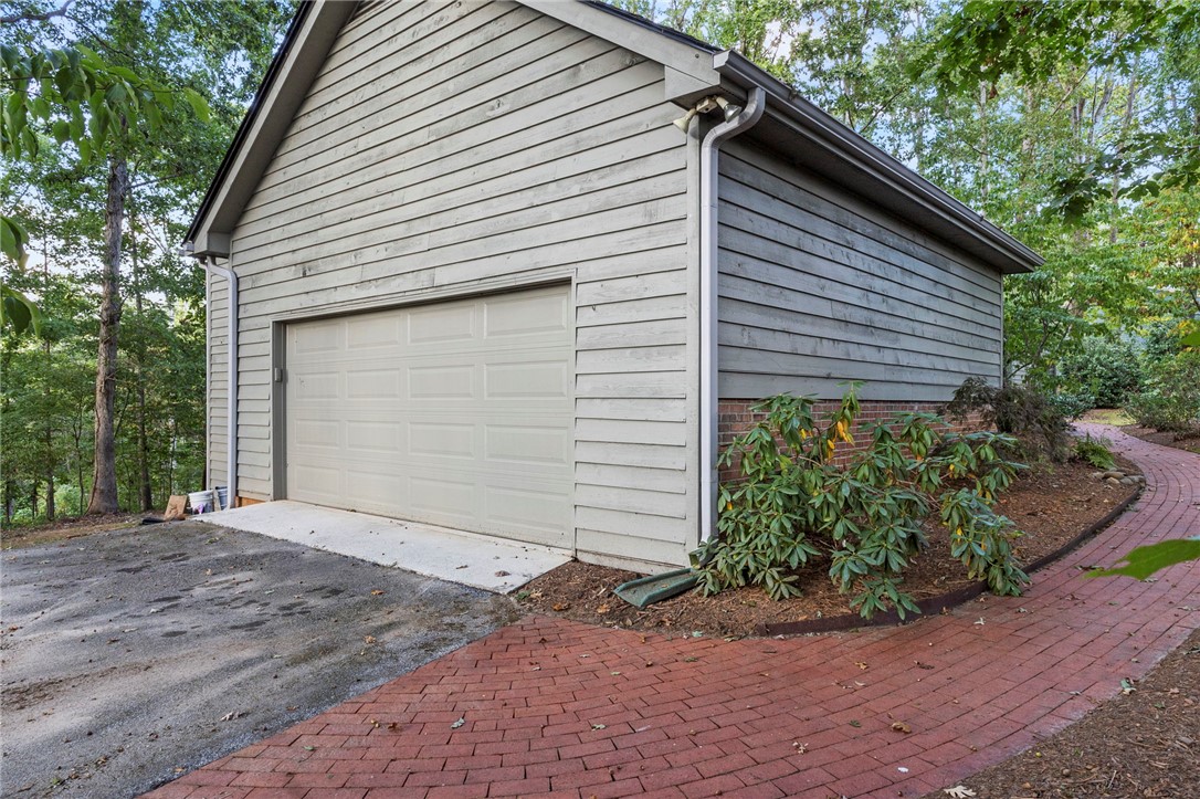 225 Arrowhead Trail Easley, SC 29642 - Photo 4 of 33 This private garage, nestled in nature, offers convenience and serene surroundings.