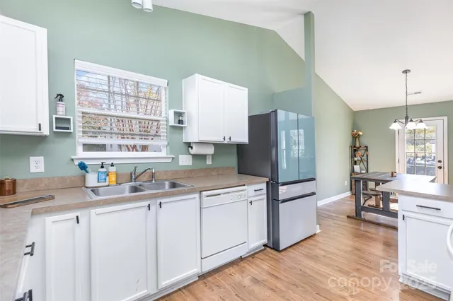 a kitchen with stainless steel appliances a refrigerator sink and cabinets