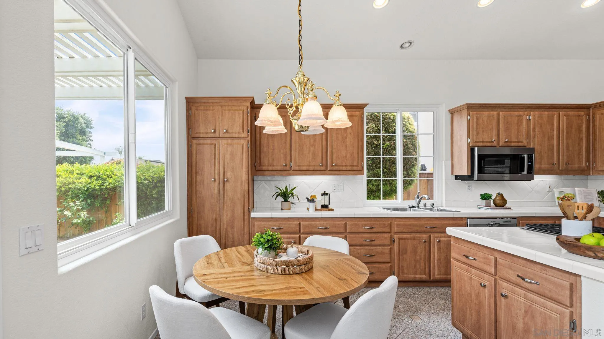 1783 Medinah Road San Marcos, CA 92069 - Photo 9 of 39 a kitchen with a table chairs sink and cabinets