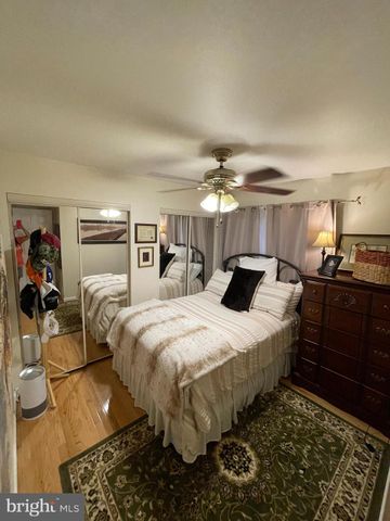 a bedroom with bed and wooden floor