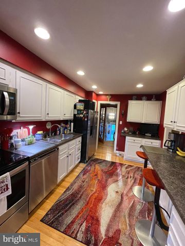 a large kitchen with lots of counter space and stainless steel appliances