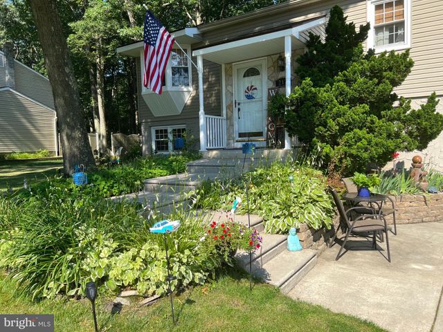 a view of a chairs and table in a backyard