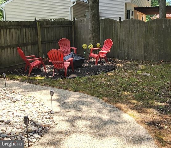 a view of a chairs and table on the balcony