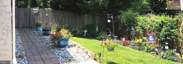 a garden with flowers and wooden fence
