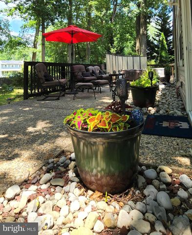 a view of a patio with chairs potted plants