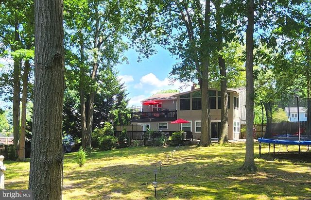 a swimming pool with outdoor seating and yard