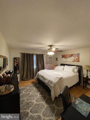 a bed sitting in a bedroom and furniture